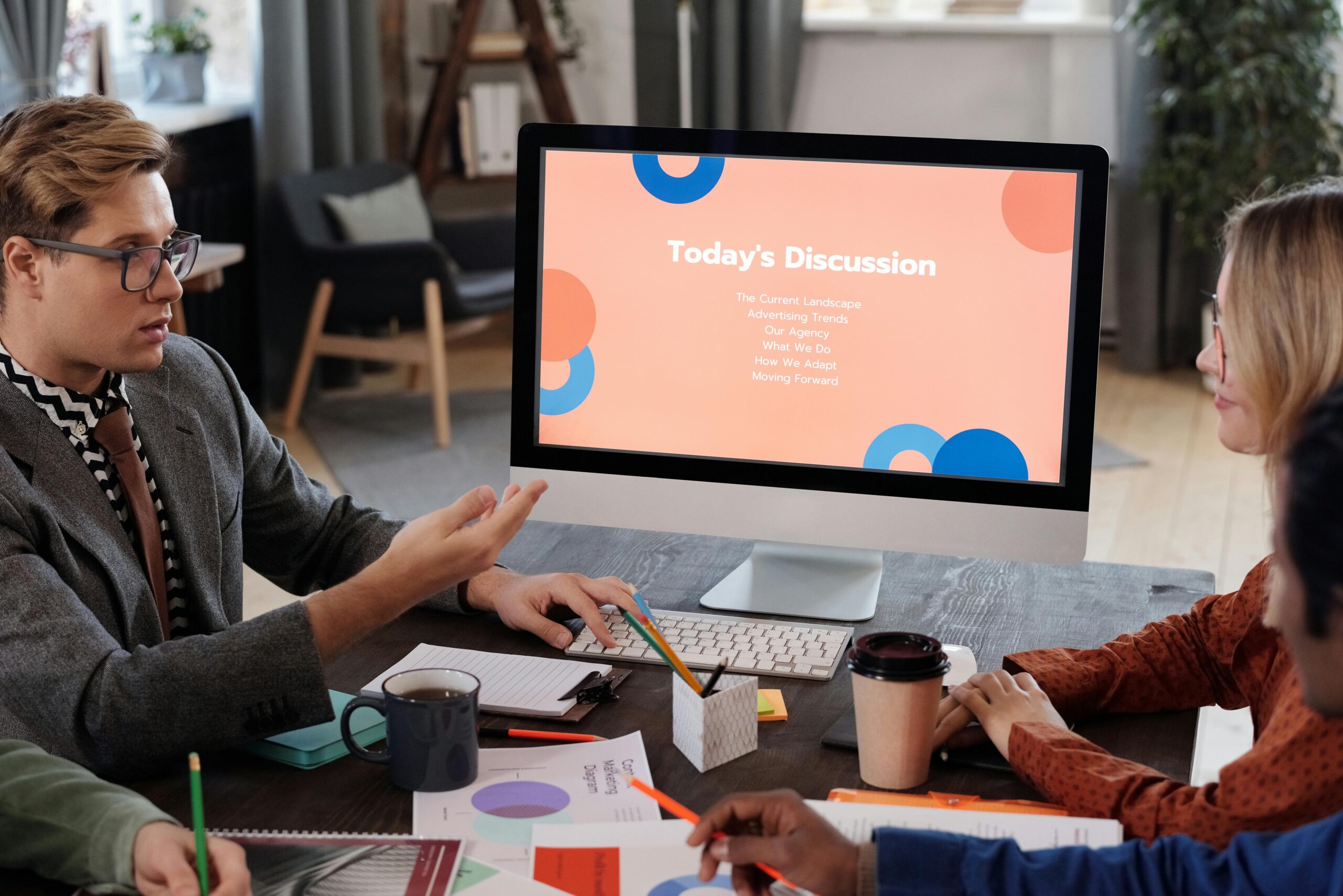 Team engaged in a productive office meeting discussing business trends and planning strategies.